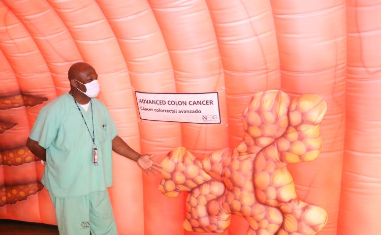 John Young Jr., a registered nurse, points out how advanced colon cancer could look when attached to the inner wall of the colon. (MORGAN MCMULLEN/Lake City Reporter)