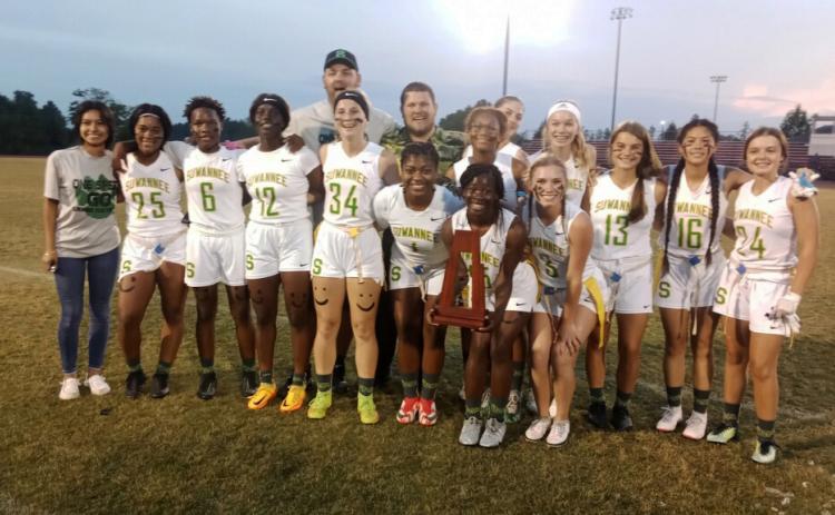 Suwannee’s flag football team celebrates with the District 2-1A trophy after defeating Florida High on Friday night. (CONCEPCION LEDEZMA/Special to the Reporter)