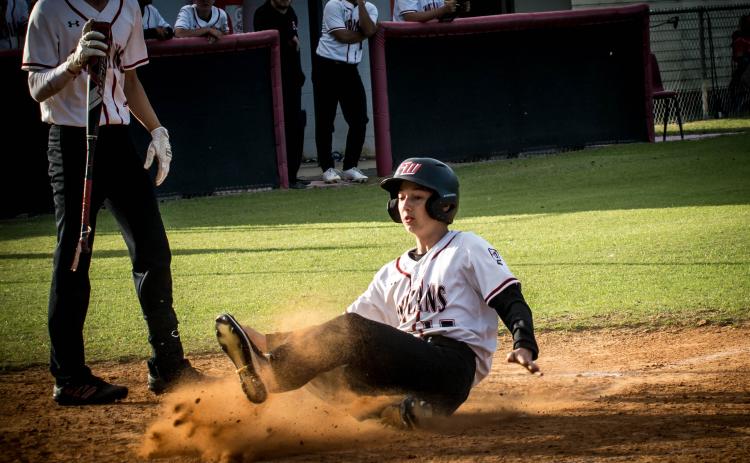 Fort White's Garrett Depaola slides safely into home plate to score a run against Taylor County on Thursday night. (CHRISTINA FEAGIN/Special to the Reporter)