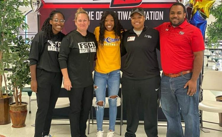 Fort White guard Jacovya Major (middle) signed her letter of intent to play at Florida State College at Jacksonville on Tuesday. Major is pictured with FSCJ assistant coach Jessica Eaton (left), FSCJ head coach Diane Couch (middle left), Fort White assistant coach Bregay Harris (middle right) and Fort White head coach DeShay Harris (right). (COURTESY)