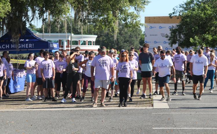 Grace Duncan’s parents Burt and Cissy (center) help lead the start of the second Grace’s Race 5K Saturday. (JAMIE WACHTER/Lake City Reporter)