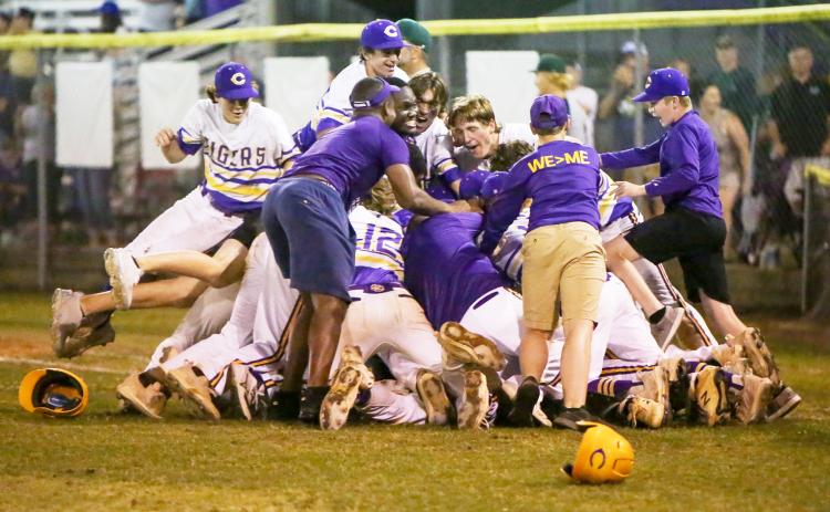 Columbia’s baseball team celebrates in a dogpile after rallying past Lincoln in the bottom of the seventh to win the Region 1-5A title on Monday to advance to the state Final Four. (BRENT KUYKENDALL/Lake City Reporter)