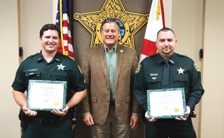 Corporal James Maulden (left) and Detention Officer Mark Collins (right) received ‘Lifesaving Medals’ from Sheriff Mark Hunter on Wednesday. (COURTESY)