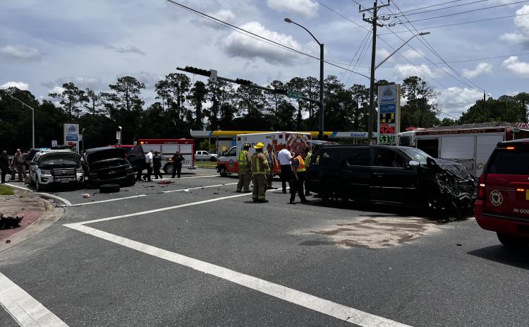 First responders clean up the intersection of SE Baya Drive and State Road 100 on Monday afternoon following a three-vehicle accident, including a Lake City Police Department SUV. (JAMIE WACHTER/Lake City Reporter)