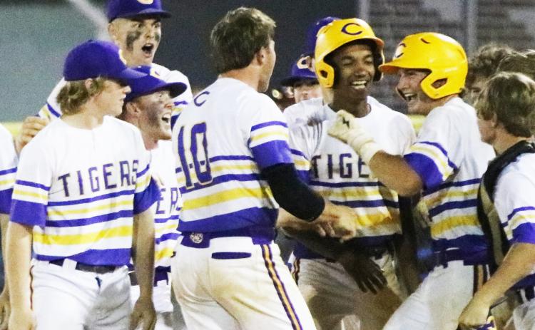 Columbia first baseman Ty Floyd (right) celebrates with teammates after hitting a walk-off single against Riverview in the District 3-5A semifinals on Tuesday. (JORDAN KROEGER/Lake City Reporter)