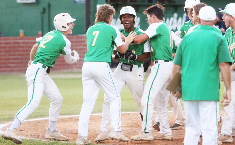 Suwannee’s Malachi Graham celebrates with his team at home plate after hitting a home run against Wakulla during the District 2-4A championship on Thursday. (PAUL BUCHANAN/Special to the Reporter)