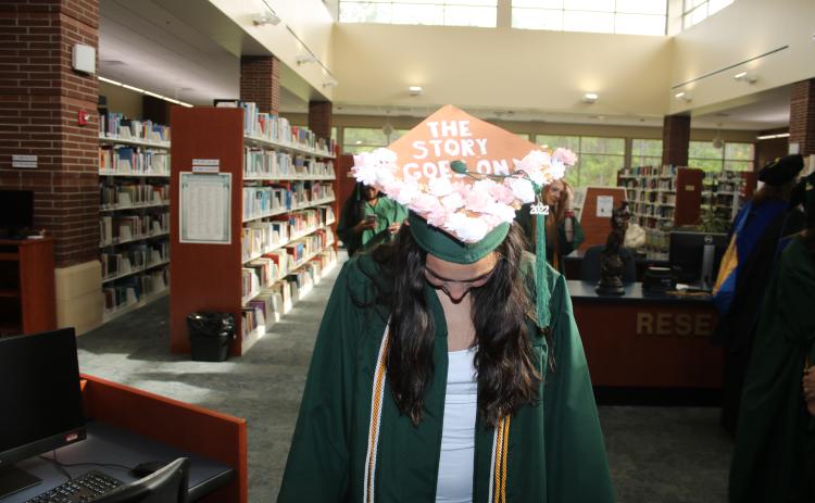 Florida Gateway College graduate Natalia Duarte shows off the decoration on her cap ahead of Friday’s commencement ceremony. (TONY BRITT/Lake City Reporter)