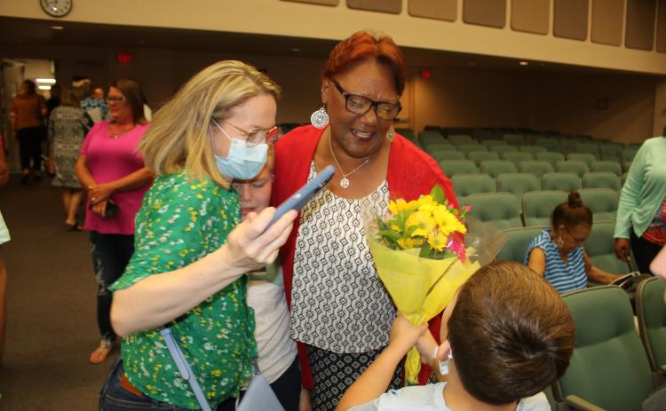 Westside Elementary school kindergarten teacher Argie Crusaw is congratulated after being honored as one of the Columbia County School District’s inaugural ‘Teacher of a Lifetime’ award winners Tuesday night. (TONY BRITT/Lake City Reporter)