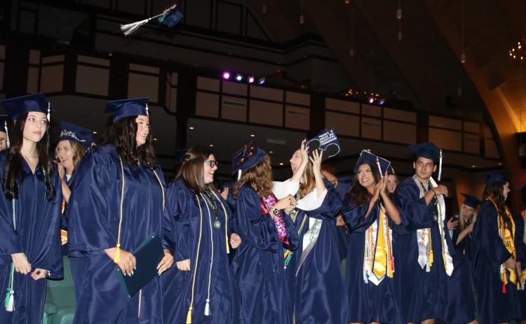 Belmont Academy Class of 2022 students react after turning their tassels and becoming graduates Friday night at Christian Fellowship Church. (TONY BRITT/Lake City Reporter)