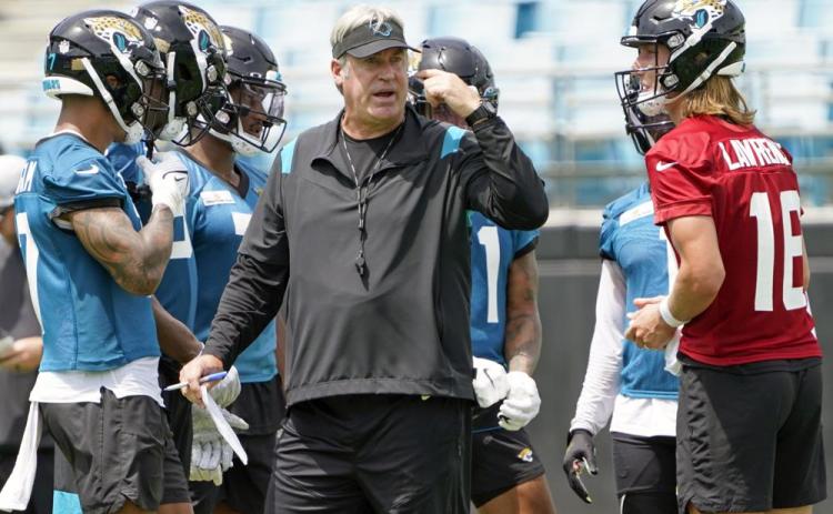 Jacksonville Jaguars head coach Doug Pederson (center) directs practice on Monday in Jacksonville. At right is quarterback Trevor Lawrence. (JOHN RAOUX/Associated Press)