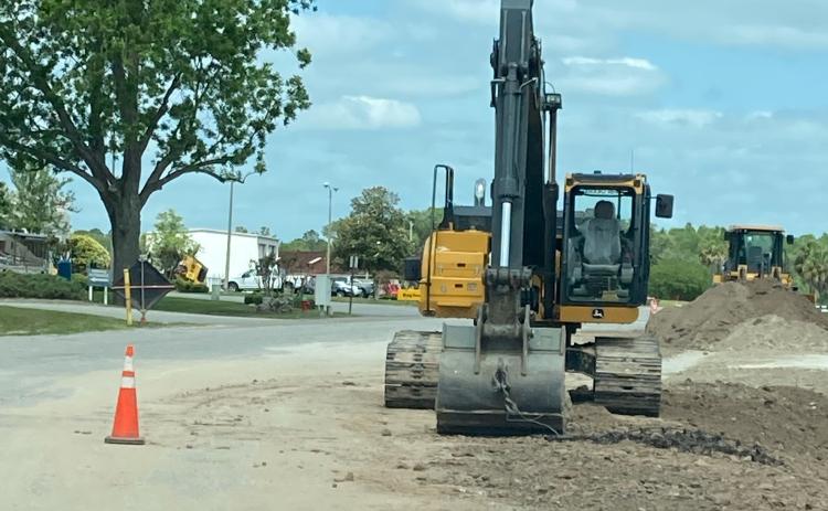 A City of Lake City contractor’s excavator is seen sitting on Ring Court without protection for the roadway. Work on the county road during a wastewater infrastructure project has Columbia County and Lake City officials bickering. (COURTESY)