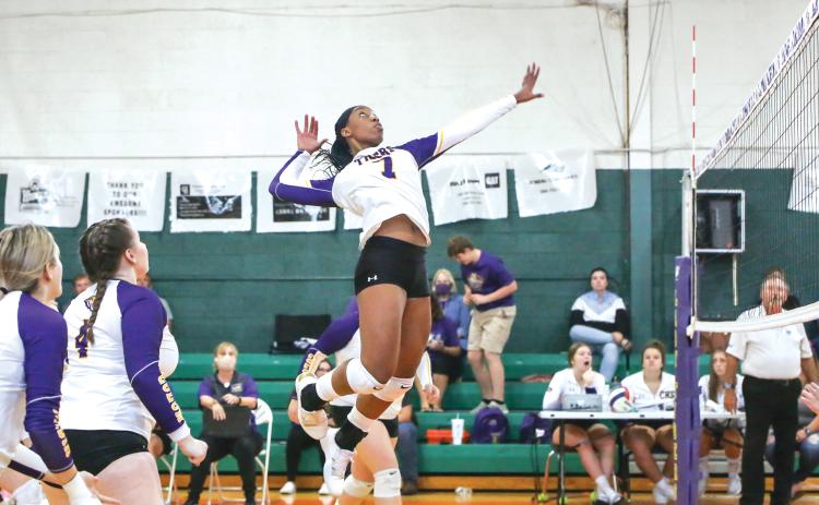 Former Columbia volleyball player Brandi Oliver rises up to hit against Fort White last season on Senior Night. (FILE)
