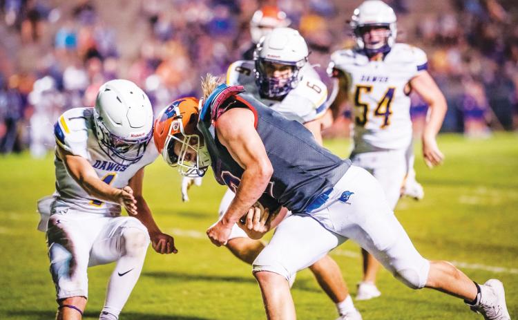 Branford running back Caden Coker meets a Bell defender during the teams’ matchup last September. The teams will face off again this fall on Sept. 9. (BRIAN LEWIS/Special to the Reporter)