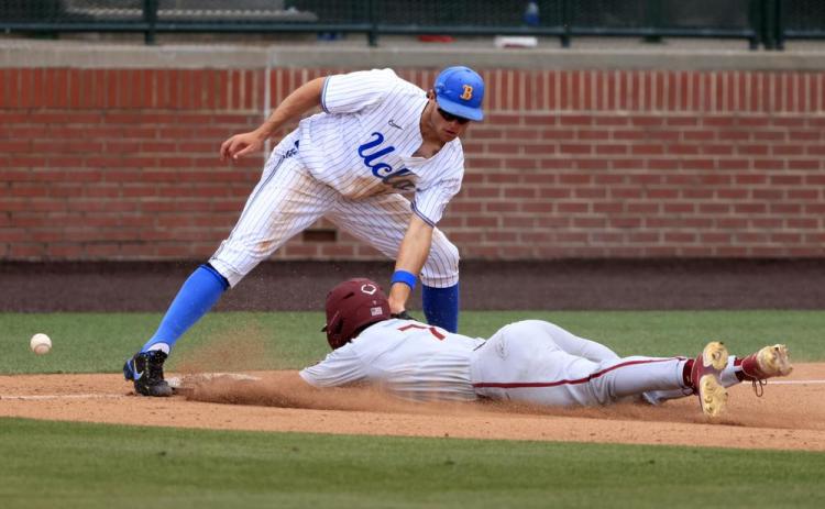 UCLA infielder Kyle Karros mishandles the ball as Florida State's Jaime Ferrer slides safely into third base on Friday in Auburn, Ala. (BUTCH DILL/Associated Press)