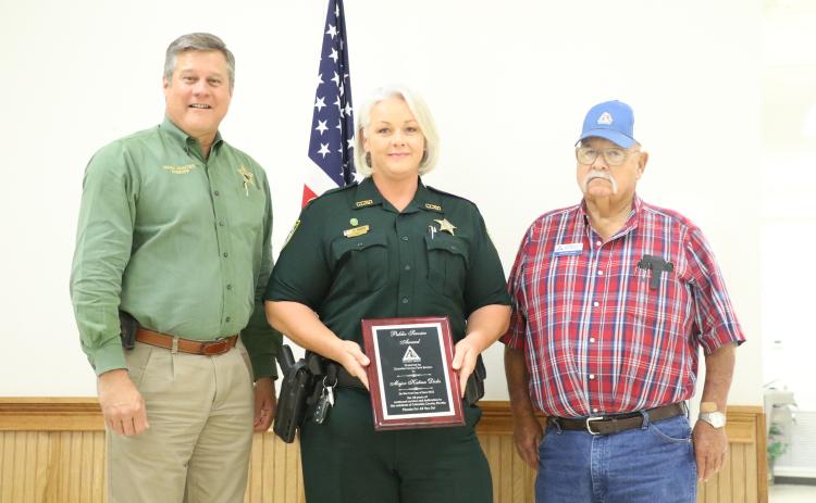 Maj. Katina Dicks (center) accepts her award at Tuesday’s Columbia County Farm Bureau dinner. (MORGAN MCMULLEN/Lake City Reporter)