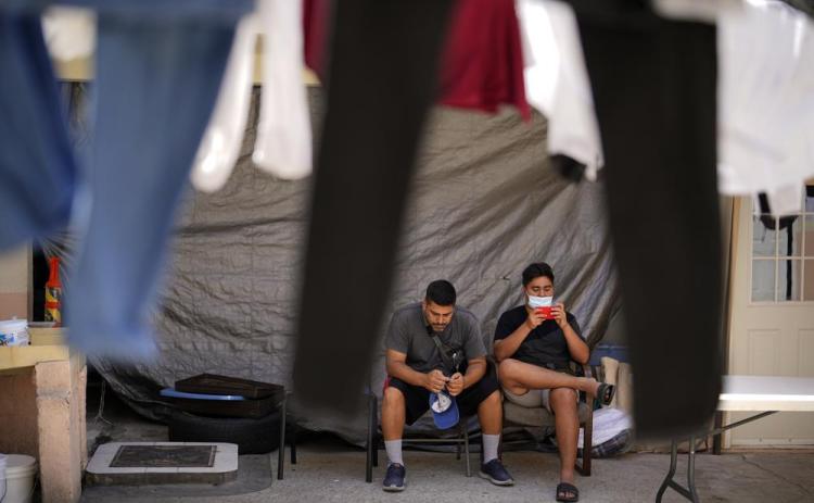 Two men from Nicaragua wait to apply for asylum in the United States Thursday, June 30, 2022, at a shelter for migrants in Tijuana, Mexico. (GREGORY BULL/Associated Press)