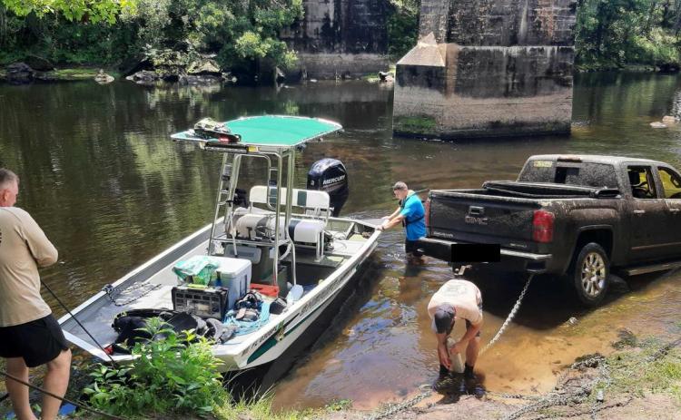 Members of the Columbia County Sheriff’s Office dive team pull a stolen pickup out of the Santa Fe River near the U.S. Highway 27 boat ramp on Monday. (PHOTOS COURTESY COLUMBIA COUNTY SHERIFF’S OFFICE)