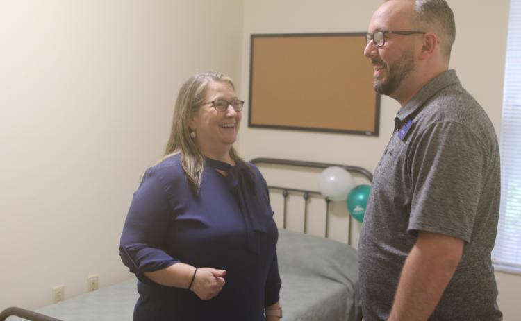 Joy Riddle, a senior vice president at Meridian, shares a laugh with Joey O’Hern, the executive director of the Lake City-Columbia County Chamber of Commerce, while showing him one of the residential rooms in the 16-bed facility. (TONY BRITT/Lake City Reporter)