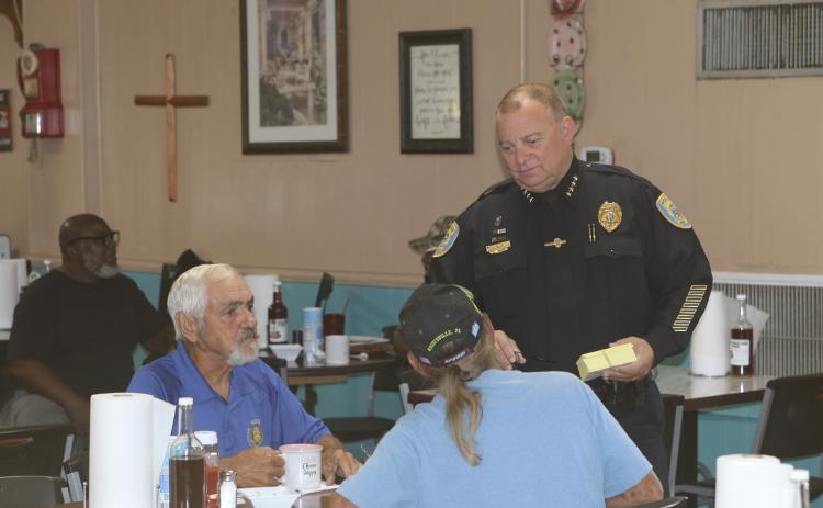 Lake City Police Department Chief Gerald Butler (right) speaks with a pair of diners at Kountry Korner on Saturday. (TONY BRITT/Lake City Reporter)