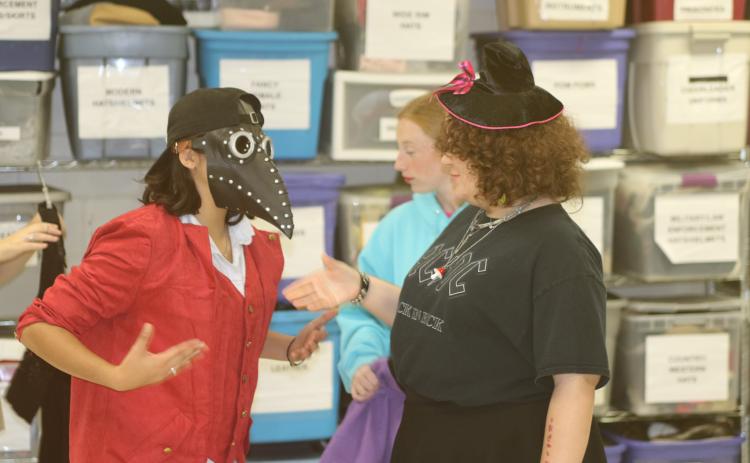 Students attending the Columbia High School Theater Camp try on various costumes Wednesday morning. Approximately 50 students have been attending the week-long camp, which culminates with a production on Friday afternoon. (TONY BRITT/Lake City Reporter)