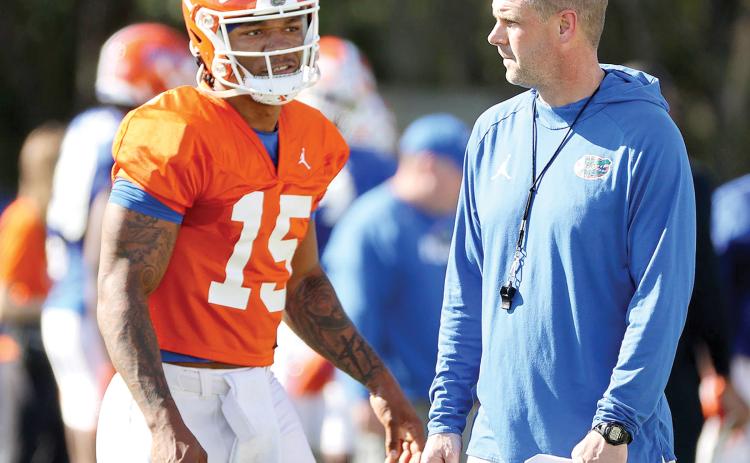Florida quarterback Anthony Richardson, talking with Gators coach Billy Napier during a spring practice, has caught UF legend Steve Spurrier’s attention. (STEPHEN M. DOWELL/Orlando Sentinel/TNS)