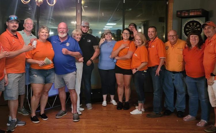 Members of the Elks Lodge pose with CCSO Deputy Shane Hartopp (black shirt) during the Lodge’s barbecue dinner fundraiser. Local residents also donated cakes to be auctioned off, with the proceeds benefiting Hartopp’s recovery from a flash bang grenade injury. (COURTESY)