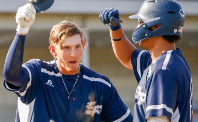 Santa Fe’s Tyler Shelnut (left) celebrates after scoring a run during a game this past season. (COURTESY OF SANTA FE ATHLETICS)