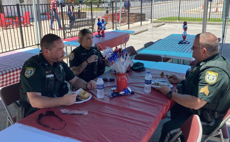 Members of the Columbia County Sheriff’s Office talk while enjoying a free lunch Friday at the First Responder Appreciation Luncheon at GulfCoast Financial Services. (TODD WILSON/Lake City Reporter)