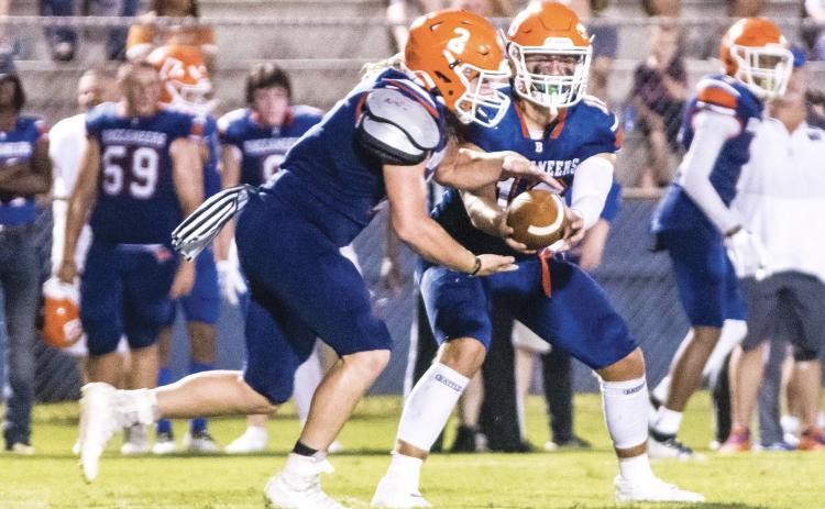 Branford quarterback Cohen David hands the ball off to running back Caden Coker during last Friday’s Preseason Classic against Fort White. (CHRISTINA FEAGIN/Special to the Reporter)
