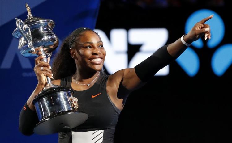 Serena Williams holds her trophy after defeating her sister Venus during the women's singles final at the Australian Open on Jan. 28, 2017, in Melbourne, Australia. (AP FILE)