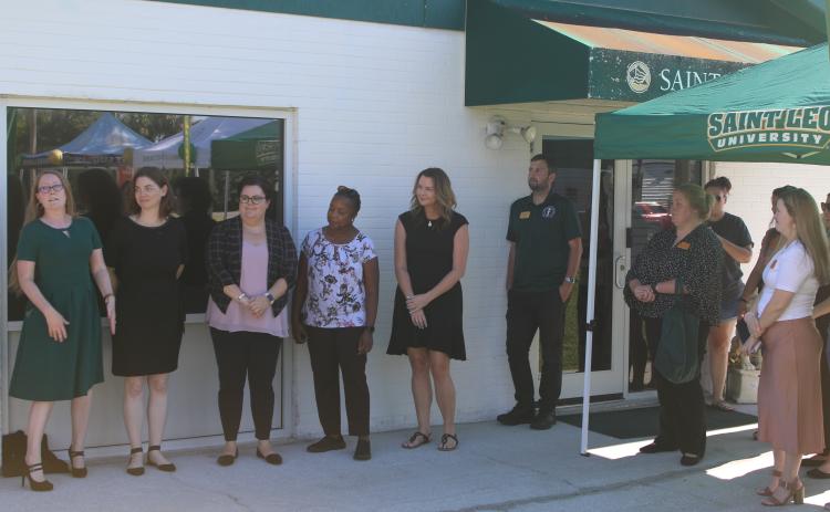 Lisa Burnham (far left) address the crowd during the Saint Leo University Lake City Education Center 25th Anniversary Celebration on Thursday afternoon. (TONY BRITT/Lake City Reporter)