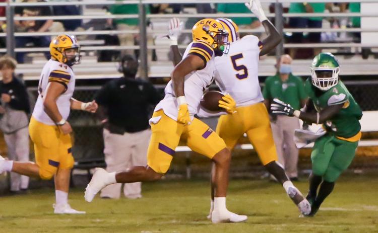 Columbia safety Amare Ferrell returns an interception 97 yards for a touchdown while Suwannee running back Marquavious Owens gives chase on Friday night in the Preseason Classic at Langford Stadium. (BRENT KUYKENDALL/Lake City Reporter)