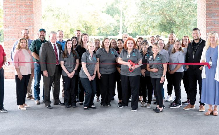 ACV Health cuts the ribbon to launch its rebrand Aug. 25 at Advent Christian VIllage’s Copeland Medical Center along with Suwannee County Chamber of Commerce and county officials. (COURTESY)