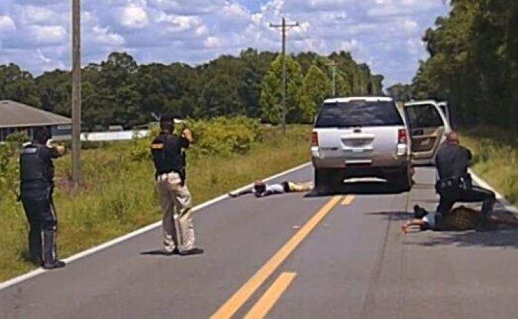Columbia County Sheriffs hold a trio of suspects at gunpoint after their vehicle fled a traffic stop following a robbery at a Dollar General Tuesday afternoon. (COURTESY CCSO)