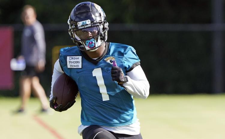 Jacksonville Jaguars running back Travis Etienne runs after a reception during practice on July 26 in Jacksonville. (JOHN RAOUX/Associated Press)