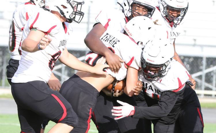 Fort White linebacker Davone Calhoun (right) and defensive tackle Jaylen Brown (above) make a tackle during a team scrimmage on Aug. 12. (MORGAN MCMULLEN/Lake City Reporter)