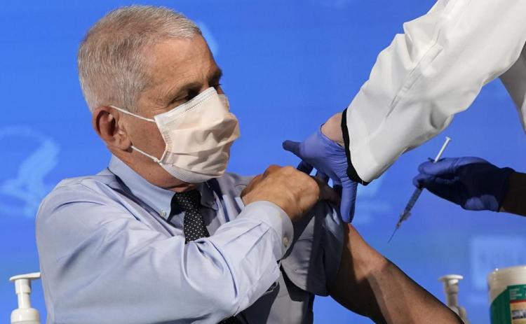 Dr. Anthony Fauci, director of the National Institute of Allergy and Infectious Diseases, prepares to receive his first dose of the covid-19 vaccine at the National Institutes of Health, Dec. 22, 2020, in Bethesda, Md. (PATRICK SEMANSKY/AP File)