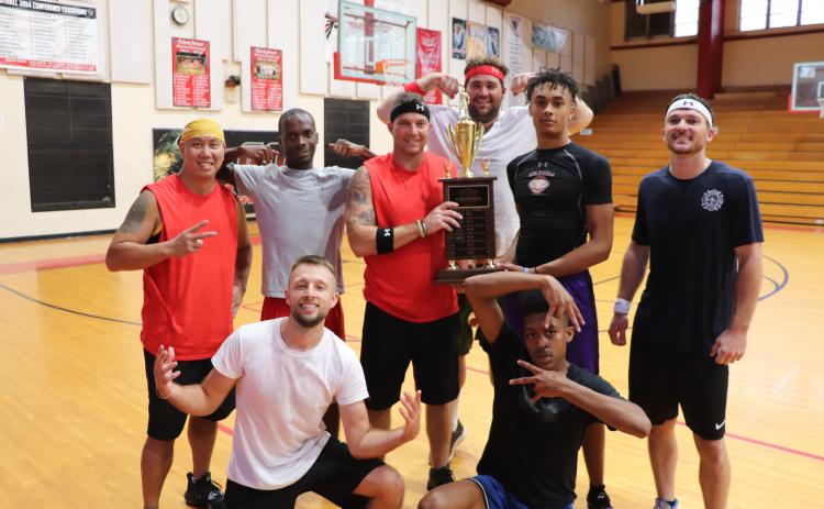 The Lake City Fire Department team poses with the newly won Boots and Badges Charity Basketball trophy. (COURTESY)