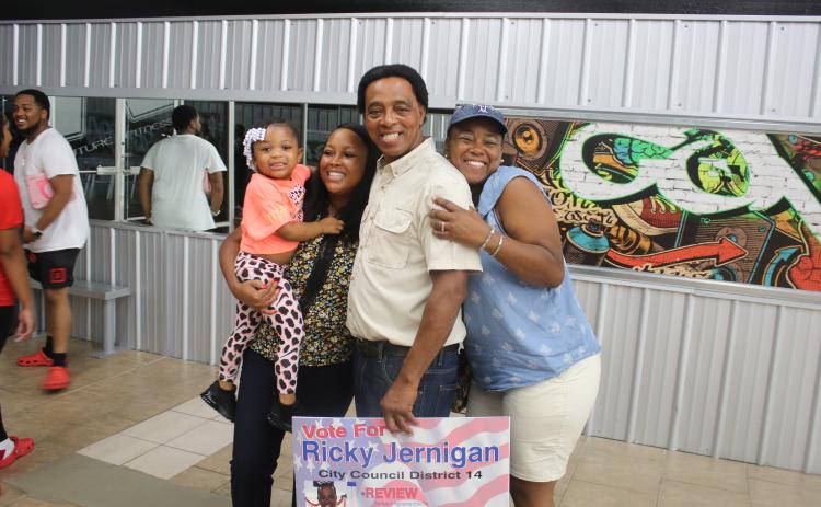 Ricky Jernigan (middle) stands with family members Ryleigh Jernigan (from left) as she’s held by Tiara Jernigan-Arline and Elena Jernigan-Highland during an election celebration party at Future Fitness on Tuesday night. (TONY BRITT/Lake City Reporter)