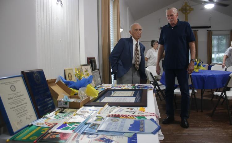 Perley Richardson (left), who has served as a Rotary Club member for 50 years, talks to Frank Loughran on Thursday evening during a ceremony honoring Richardson and his service to the organization. (TONY BRITT/Lake City Reporter)