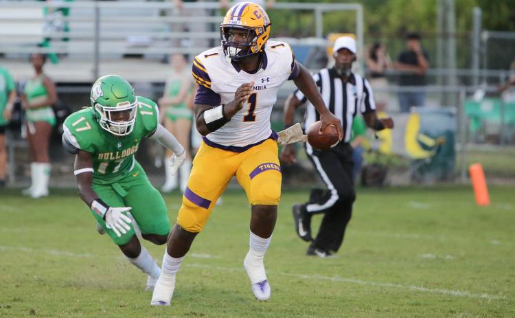 Columbia quarterback Tyler Jefferson is chased by Suwannee linebacker Delwyn Allen during Friday’s Preseason Classic. (BRENT KUYKENDALL/Lake City Reporter)