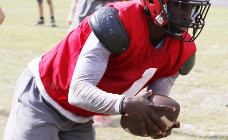 Lafayette’s Karlos Murphy scoops up a fumble during practice on Aug. 3. (JAMIE WACHTER/Lake City Reporter)
