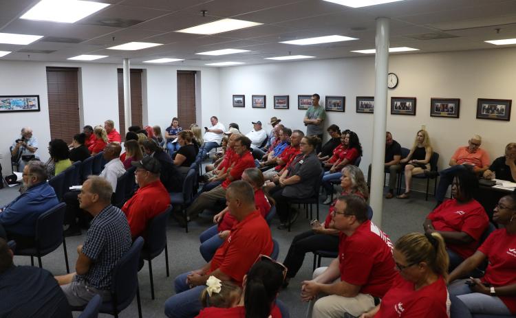 HAECO Americas employees and supporters wore matching red shirts to Thursday’s city council meeting. The city and HAECO are currently negotiating a renewal of HAECO’s lease at Lake City Gateway Airport. (MORGAN MCMULLEN/Lake City Reporter)