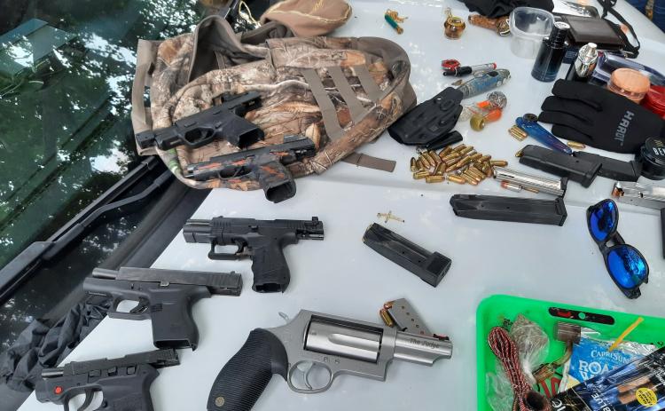 Firearms and drug paraphernalia are laid out after being confiscated from a trio of teens Tuesday. (COURTESY CCSO)