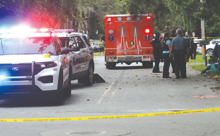 First responders arrived at the scene of a shooting incident around 5:05 p.m. Friday near Melrose Park Elementary School, cordoning off the intersection of SE Putnam Street and SE Baker Avenue. (TONY BRITT/Lake City Reporter)