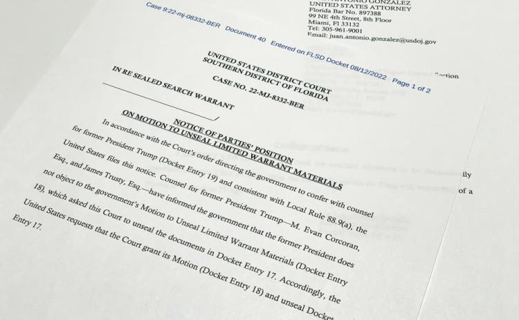 The notice filed by the Justice Department to the U.S. District Court South District of Florida informing the judge that lawyers for former President Donald Trump did not object to the government's motion to unseal the search warrant for Trump's Mar-a-Lago estate, is photographed Friday. (JON ELWICK/Associated Press)