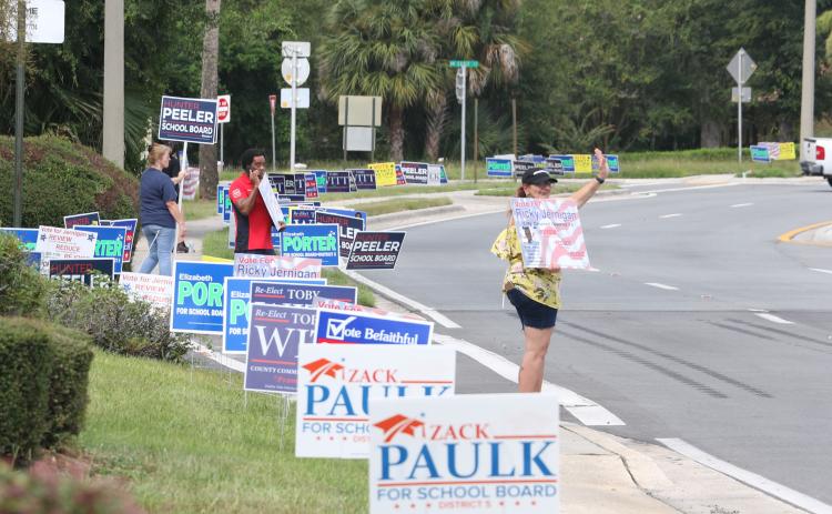 The entrance to the Supervisor of Elections office in Lake City shows a roadside packed with campaign signs on the first day of early voting. (MORGAN MCMULLEN/Lake City Reporter)