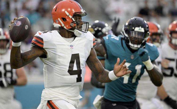 Cleveland Browns quarterback Deshaun Watson looks for a receiver as he is pressured by Jacksonville Jaguars linebacker Josh Allen during Friday’s preseason game in Jacksonville. (PHELAN M. EBENHACK/Associated Press)