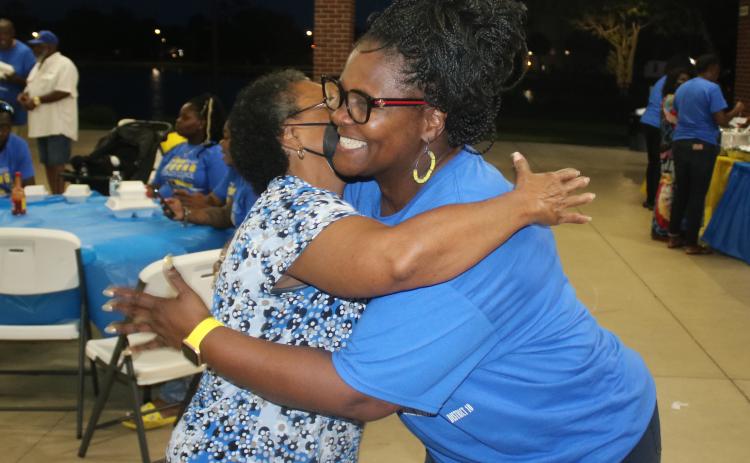 Chevella Young hugs supporter Linda Thomas at Darby Pavillion on Tuesday night after learning she was elected to the Lake City Council. (TONY BRITT/Lake City Reporter)