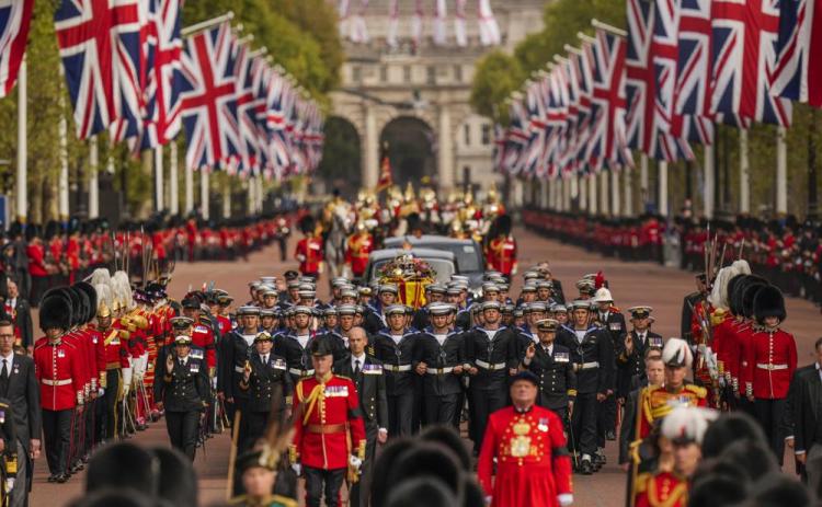 The coffin of Queen Elizabeth II is pulled past Buckingham Palace following her funeral service in Westminster Abbey in central London on Monday. (VADIM GHIRDA/Associated Press)